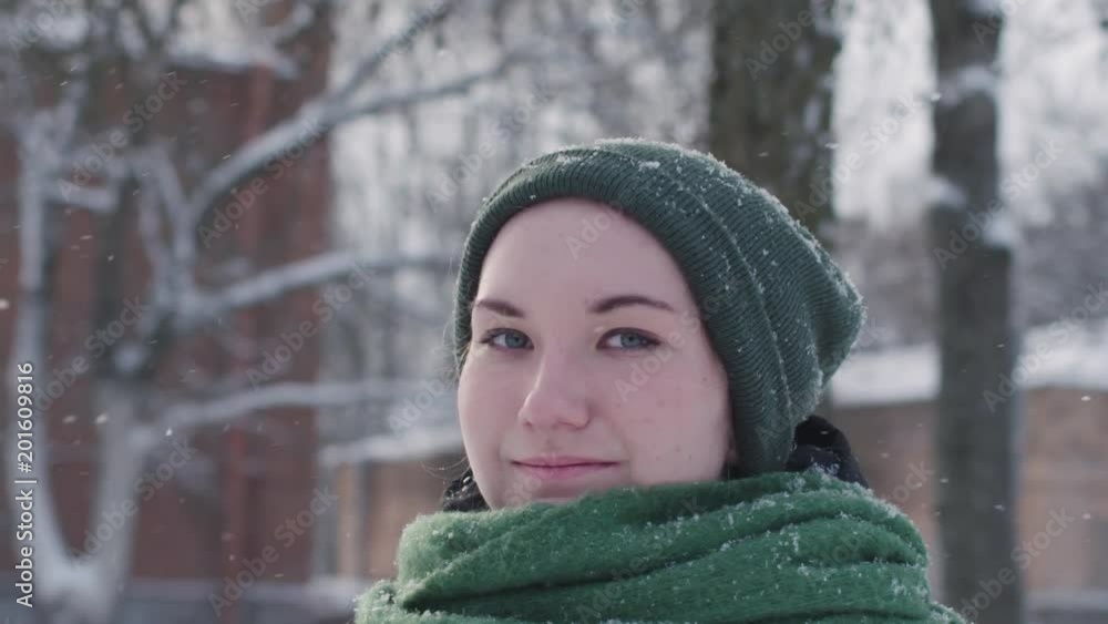 Slow motion portrait of teen girl standing on city street on a sunny winter day Slow motion portrait of teen girl standing on city street on a sunny winter day