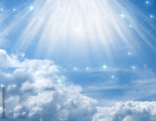 divine, mystical, angelic blue background with cloudy sky, rays of light and stars  photo