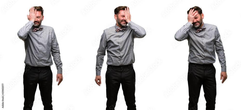 Middle age man, with beard and bow tie stressful keeping hand on head, tired and frustrated Middle age man, with beard and bow tie stressful keeping hand on head, tired and frustrated