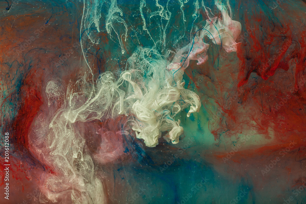 Fototapeta premium Color paint drops in water. Ink swirling underwater.