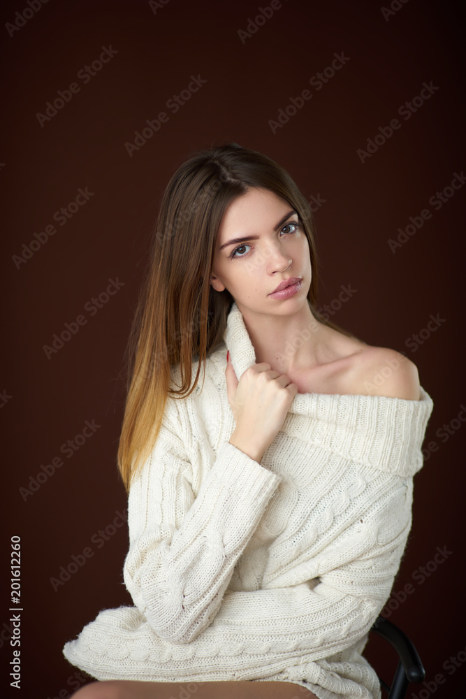 Concept: professional fashion lifestyle. Beautiful model posing in studio during classic test shooting wearing white sweater and white lingerie. Woman show poses and emotions. Concept: professional fashion lifestyle. Beautiful model posing in studio during classic test shooting wearing white sweater and white lingerie. Woman show poses and emotions.