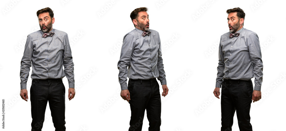 Middle age man, with beard and bow tie happy and surprised cheering expressing wow gesture Middle age man, with beard and bow tie happy and surprised cheering expressing wow gesture