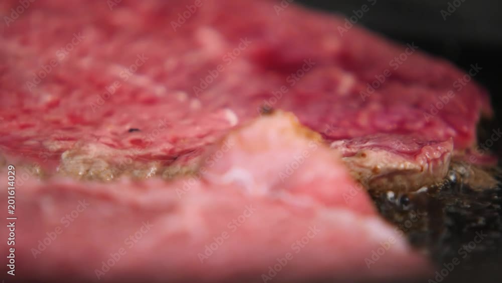 Cooking a juicy slice of steak. Cooking a juicy slice of steak.