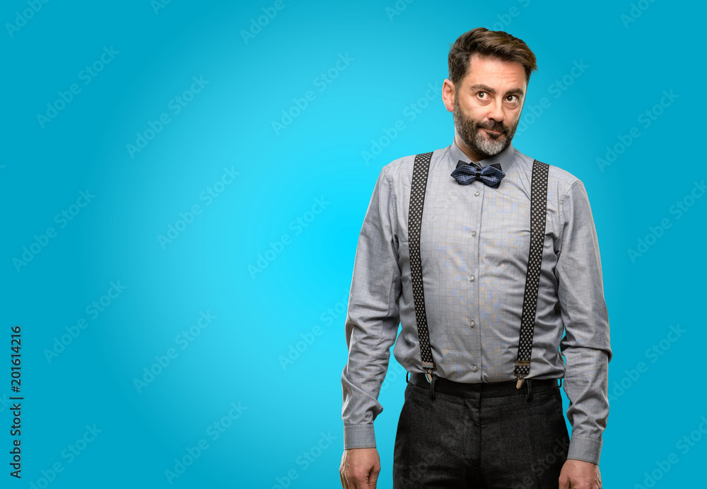 Fototapeta premium Middle age man, with beard and bow tie doubt expression, confuse and wonder concept, uncertain future