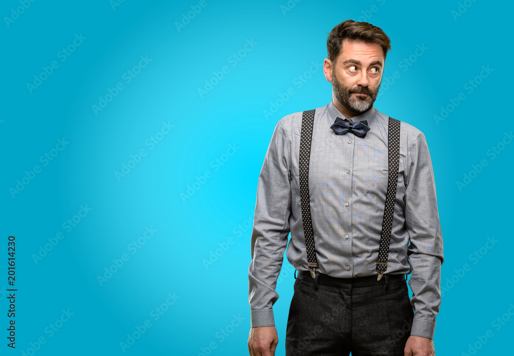 Middle age man, with beard and bow tie doubt expression, confuse and wonder concept, uncertain future Middle age man, with beard and bow tie doubt expression, confuse and wonder concept, uncertain future