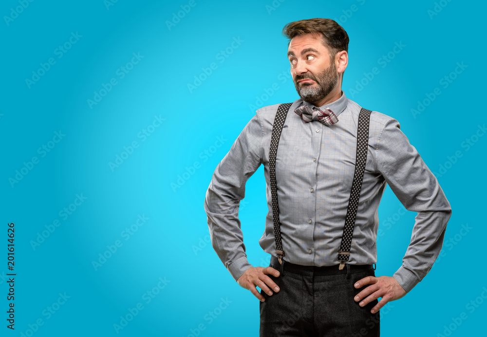 Fototapeta premium Middle age man, with beard and bow tie doubt expression, confuse and wonder concept, uncertain future