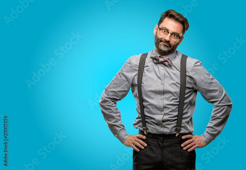 Photography Middle age man, with beard and bow tie making funny face fooling