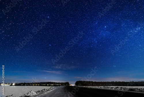 Starry sky over the winter road.