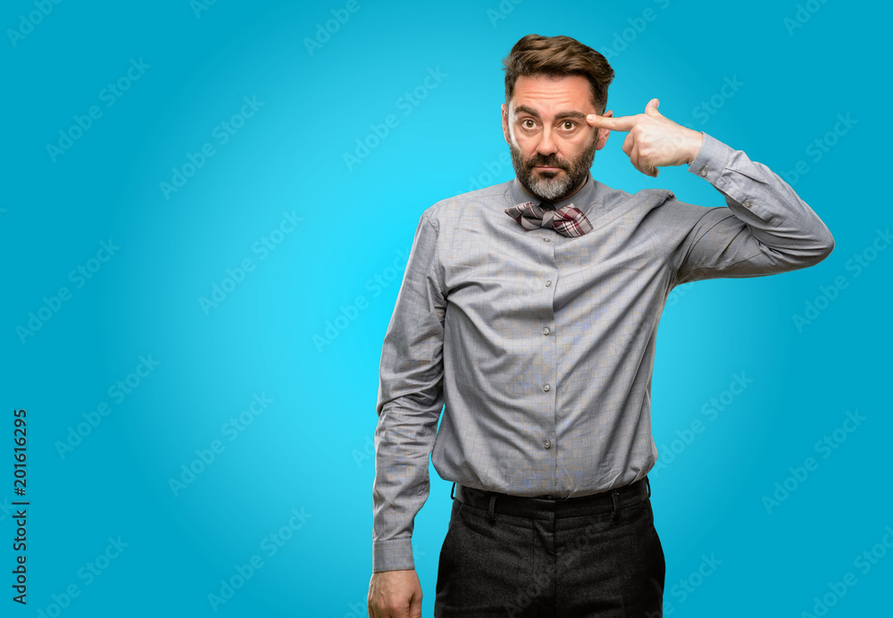 Middle age man, with beard and bow tie unhappy making suicide gesture, tired of everything. Shoots with hand imitating gun, upset Middle age man, with beard and bow tie unhappy making suicide gesture, tired of everything. Shoots with hand imitating gun, upset