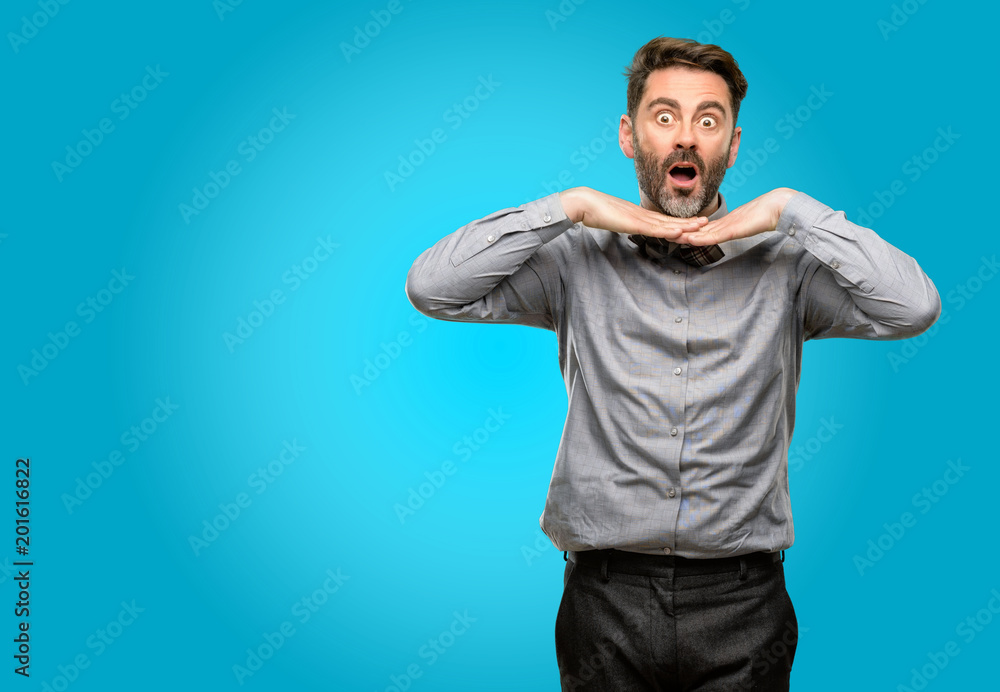 Middle age man, with beard and bow tie happy and surprised cheering expressing wow gesture Middle age man, with beard and bow tie happy and surprised cheering expressing wow gesture