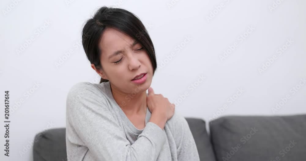 Woman feeling tired and shoulder pain at home Woman feeling tired and shoulder pain at home