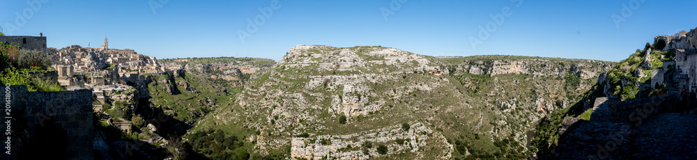 Panoramic View of the Belvedere on the Gravina of the city of Matera, on blue Sky Bacground. Matera, South of Italy