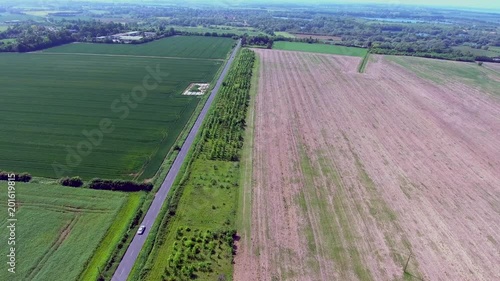 Green and brown fields in british countryside from above via drone photo