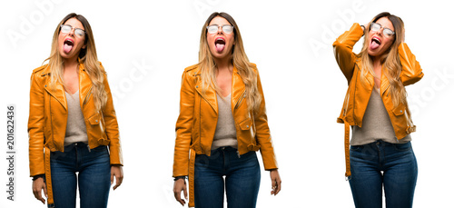 Beautiful young woman feeling disgusted with tongue out over white background