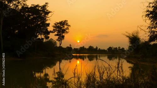 4K Time lapse sunset scene over lagoon,incoming dark at Thailand countryside