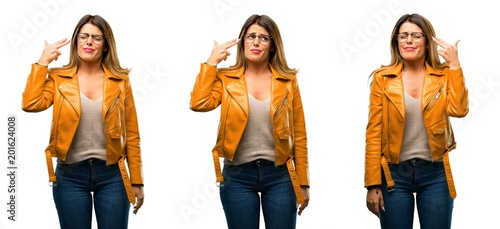 Beautiful young woman unhappy making suicide gesture, tired of everything. Shoots with his hand imitating gun, upset over white background