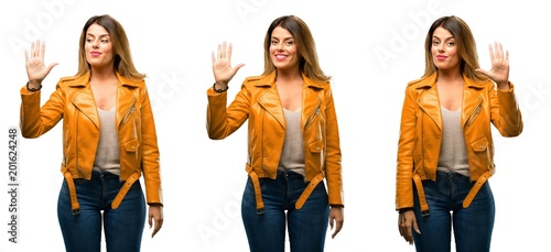 Beautiful young woman raising his finger  is the number five over white background