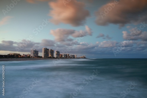 Facing North from Deerfield Beach Pier the Foam and Froth of the Waves of the Atlantic Ocean Blurred in a Long Time Exposure with Condos in the Background After Dusk © kthx1138