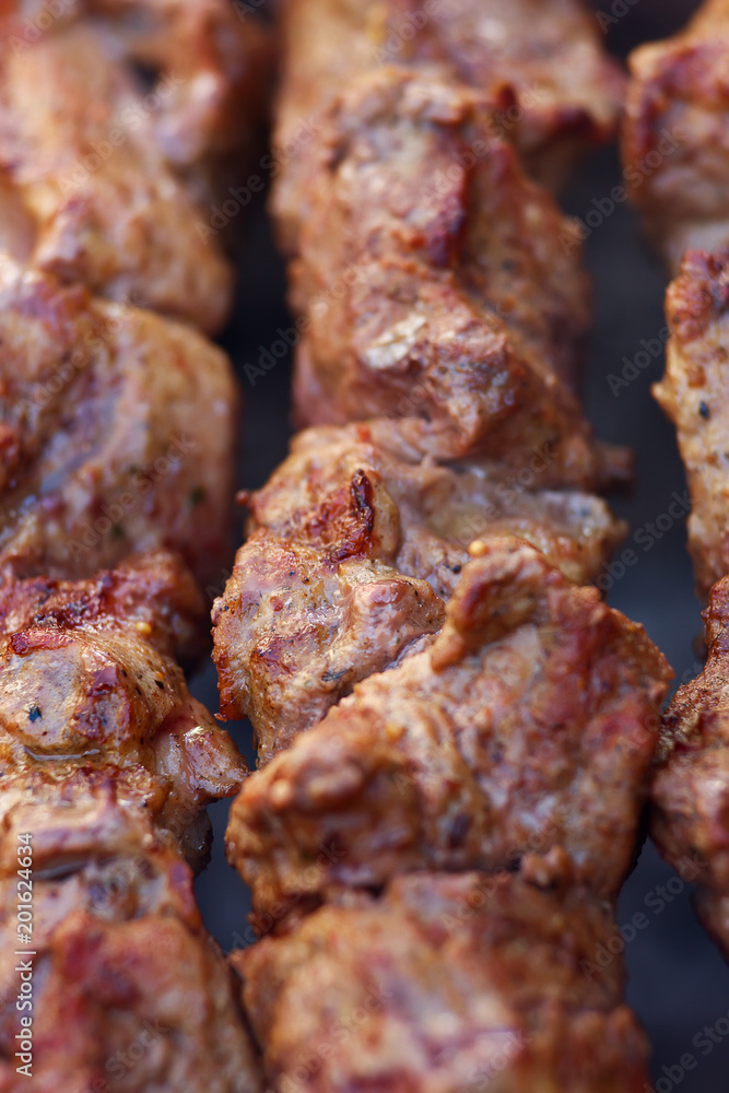 Excellent fresh juicy pieces of meat shish kebab fry on charcoal grill. Roast the meat close up Excellent fresh juicy pieces of meat shish kebab fry on charcoal grill. Roast the meat close up