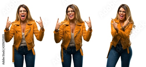 Beautiful young woman making rock symbol with hands  shouting and celebrating over white background
