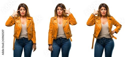 Beautiful young woman unhappy making suicide gesture  tired of everything. Shoots with his hand imitating gun  upset over white background