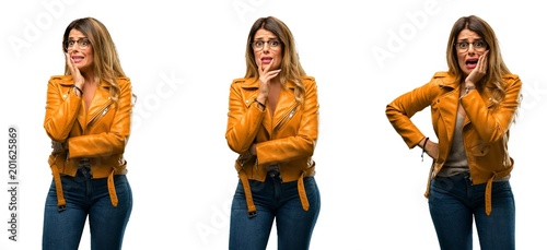Beautiful young woman scared in shock  expressing panic and fear over white background