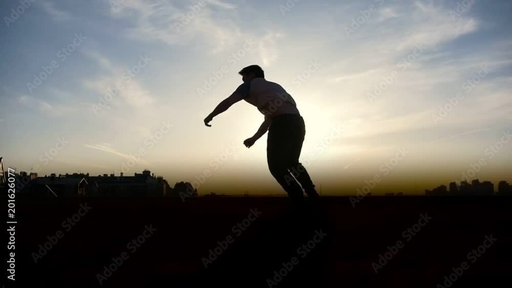 Parkour tricker jumper performs amazing flips, silhouette Parkour tricker jumper performs amazing flips, silhouette