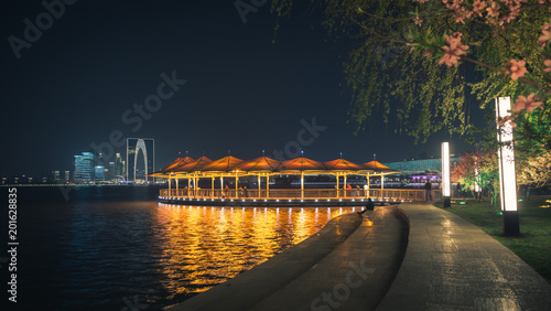 Cityscape of illuminated waterfront with pier