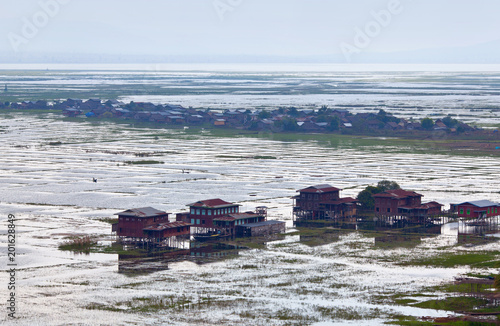 Panoramic view of Intha village on wooden piles over water on Inle lake, Shan state, Myanmar photo