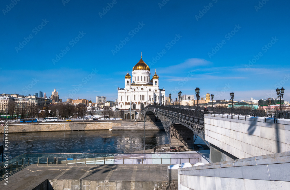 The new building of Russian Orthodox Cathedral of Christ the Saviour and the Patriarchy bridge over the Moscow River in Moscow.