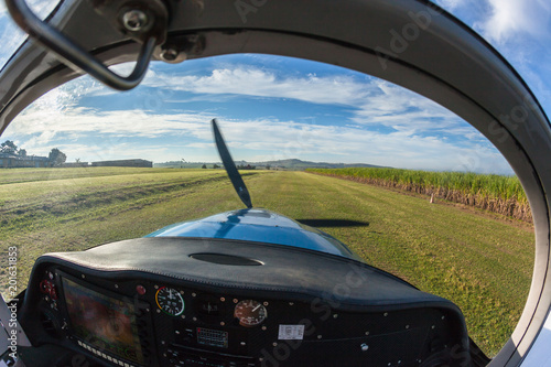Fototapeta Naklejka Na Ścianę i Meble -  Prop Plane Take Off Inside Out Grass Airfield