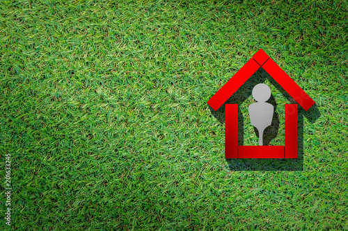 house ideas concept with shape of 3d rendering house with symbol people inside on green grass floor texture background © whyframeshot