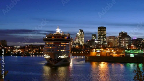 Massive cruise ship making departure turn in port with cityscape photo