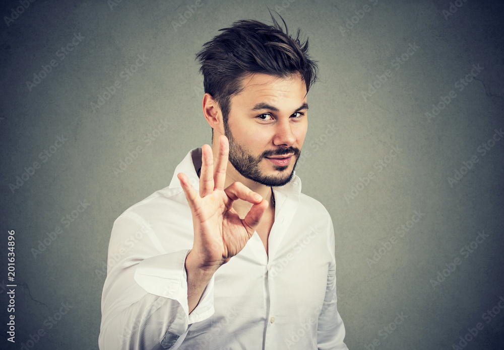 handsome confident man showing ok sign handsome confident man showing ok sign