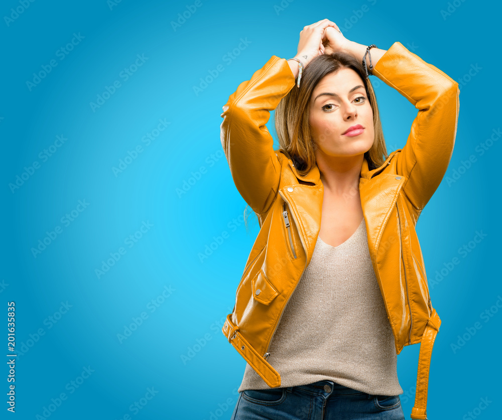 Beautiful young woman confident and happy with a big natural smile, blue background Beautiful young woman confident and happy with a big natural smile, blue background