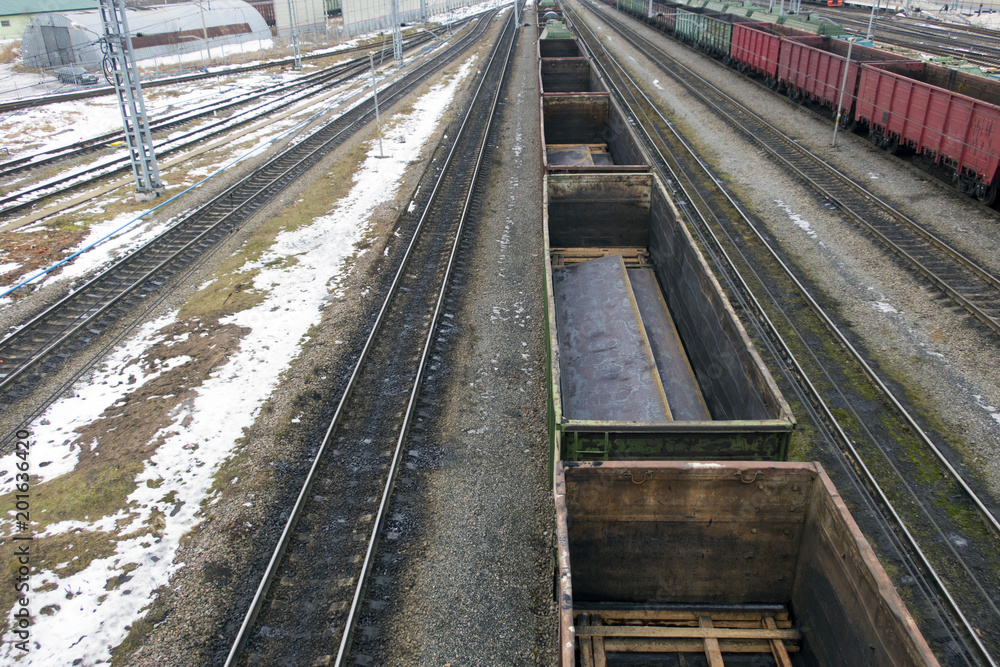 Railway station in winter and freight trains