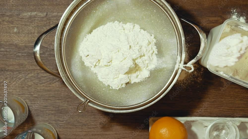 Making a sweet pie at home. We need flour. Before use, we sieve it through a sieve. Making a sweet pie at home. We need flour. Before use, we sieve it through a sieve.