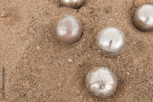 Beach. A game of Bocha. Brilliant silver balls for a bocha on the sand.