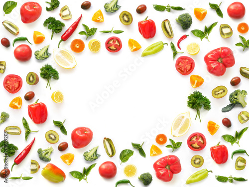 The concept of healthy eating. Pattern composition from vegetables and fruits, top view. Food background, vegetable frame. Tomatoes, pepper, lemon, kiwi, basil, parsley isolated on white background.