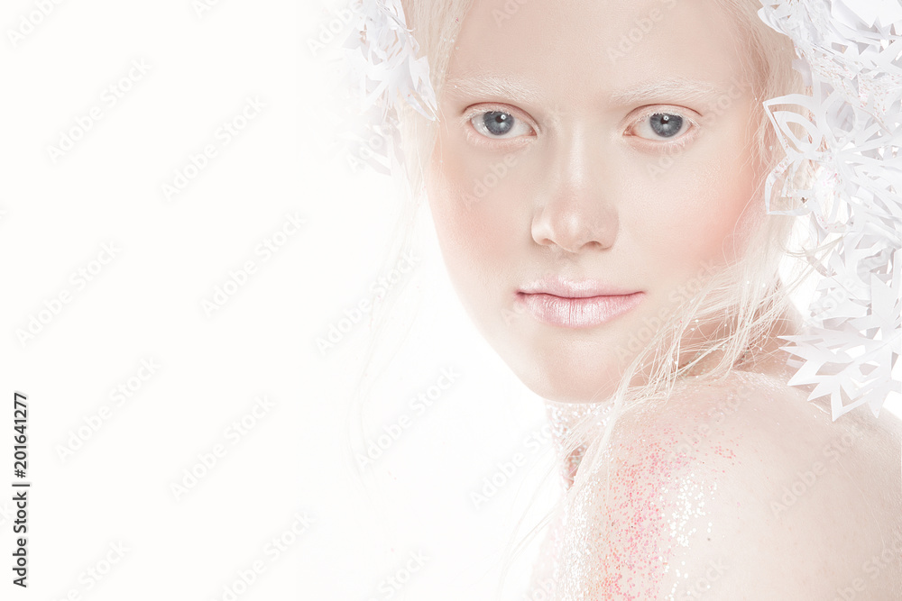 A very delicate portrait of an albino girl, a white background, snowflakes in her hair, sparkles, a magical winter image. Natural make-up, pink lipstick on lips. A very delicate portrait of an albino girl, a white background, snowflakes in her hair, sparkles, a magical winter image. Natural make-up, pink lipstick on lips.