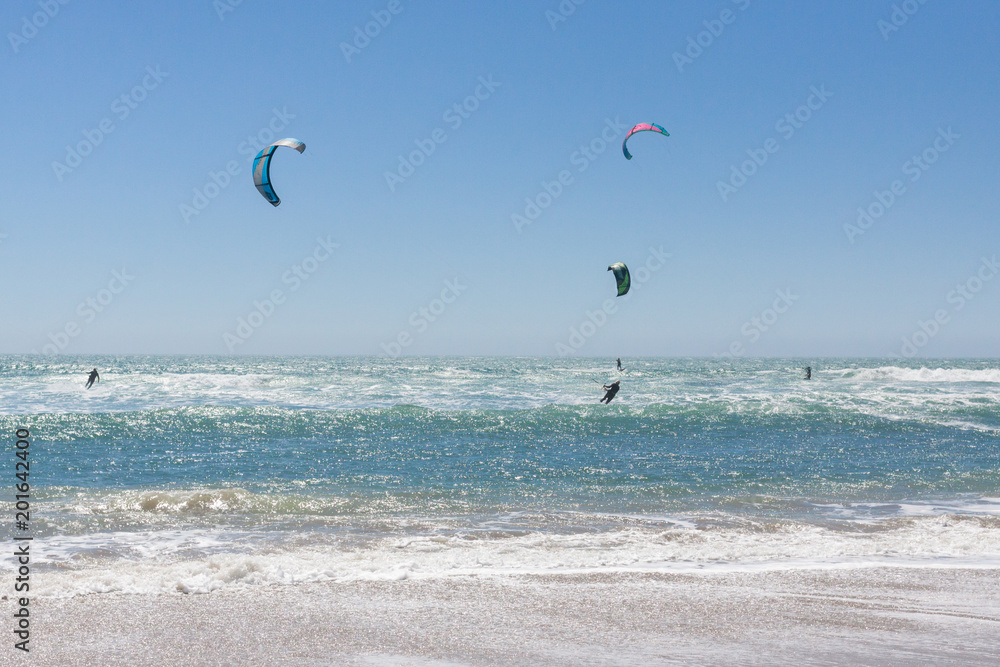 Kite surfers in the Ocean. California coast way. Highway 1. USA Kite surfers in the Ocean. California coast way. Highway 1. USA