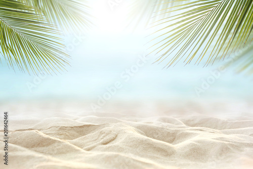 Fototapeta Naklejka Na Ścianę i Meble -  Sand with blurred Palm and tropical beach and sea background, Summer vacation and travel concept. Copy space