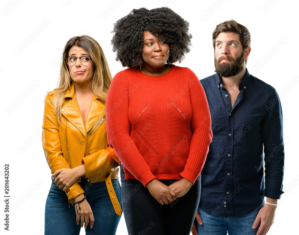 Group of three young men and women doubt expression, confuse and wonder concept, uncertain future Group of three young men and women doubt expression, confuse and wonder concept, uncertain future