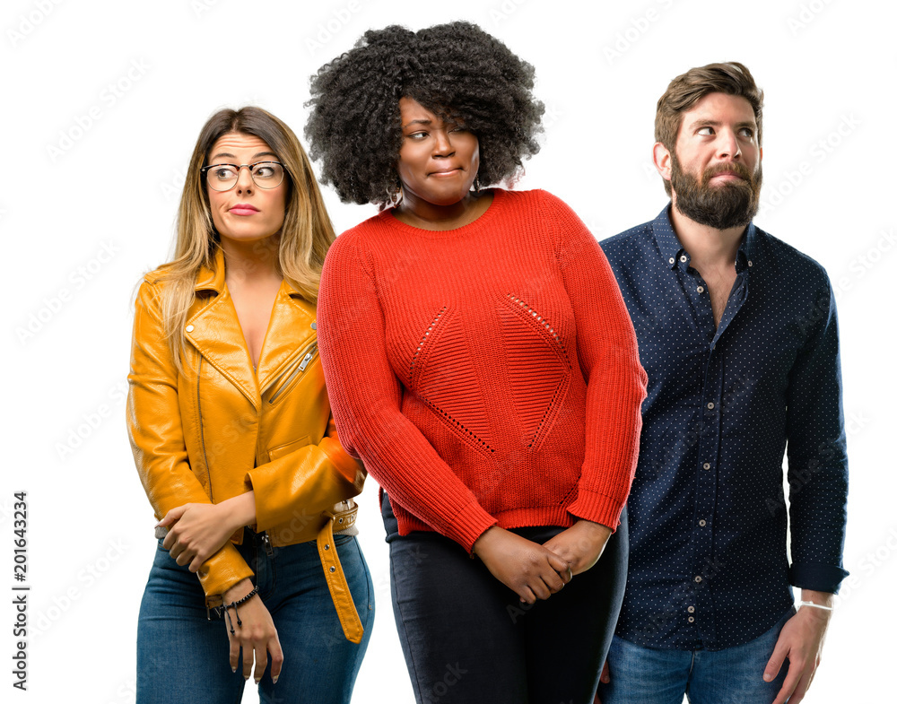 Group of three young men and women doubt expression, confuse and wonder concept, uncertain future Group of three young men and women doubt expression, confuse and wonder concept, uncertain future