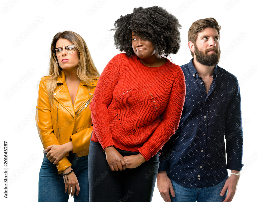 Group of three young men and women doubt expression, confuse and wonder concept, uncertain future Group of three young men and women doubt expression, confuse and wonder concept, uncertain future
