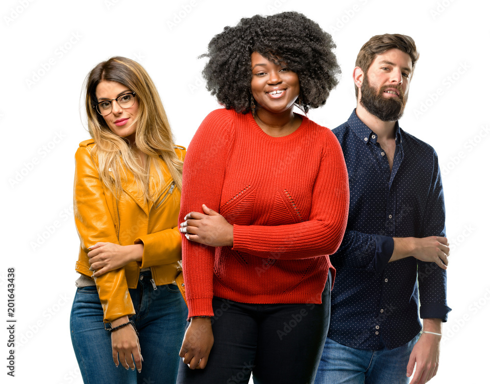 Group of three young men and women confident and happy with a big natural smile laughing Group of three young men and women confident and happy with a big natural smile laughing