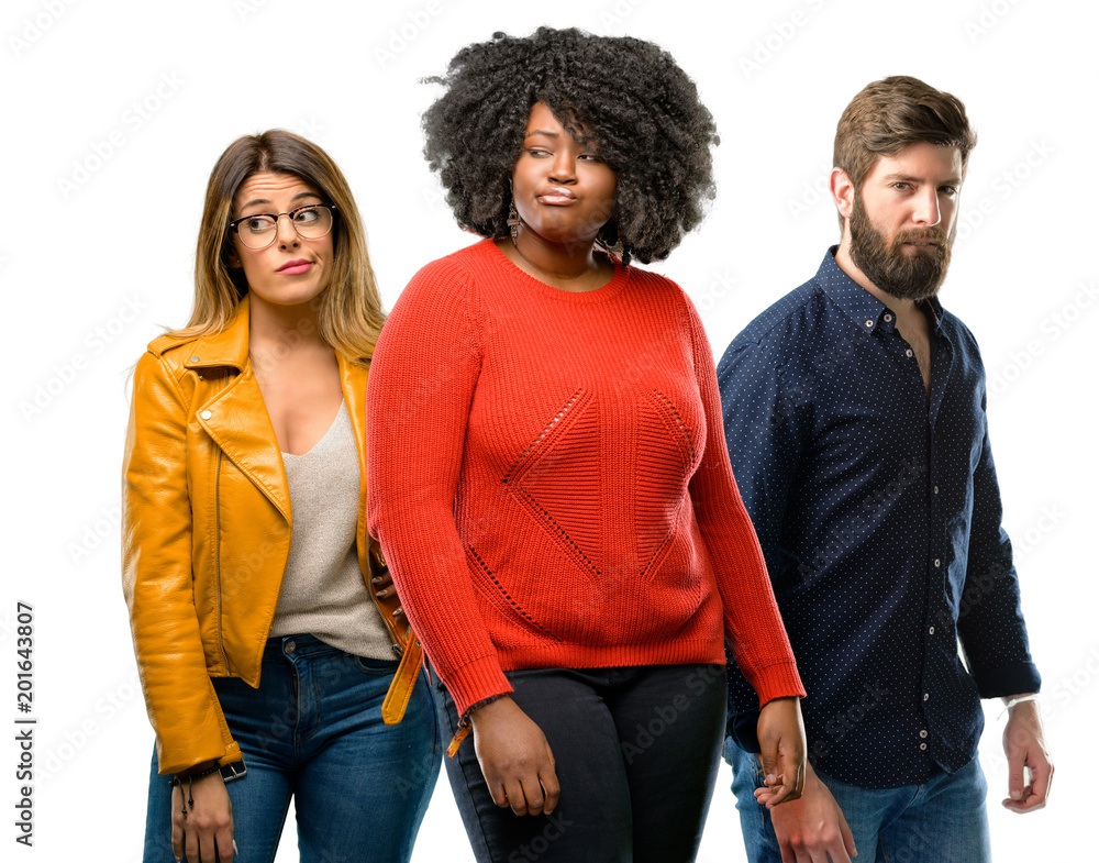 Group of three young men and women doubt expression, confuse and wonder concept, uncertain future Group of three young men and women doubt expression, confuse and wonder concept, uncertain future