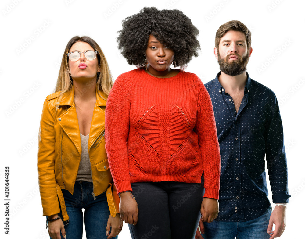 Group of three young men and women expressing love, blows kiss at camera, flirting Group of three young men and women expressing love, blows kiss at camera, flirting