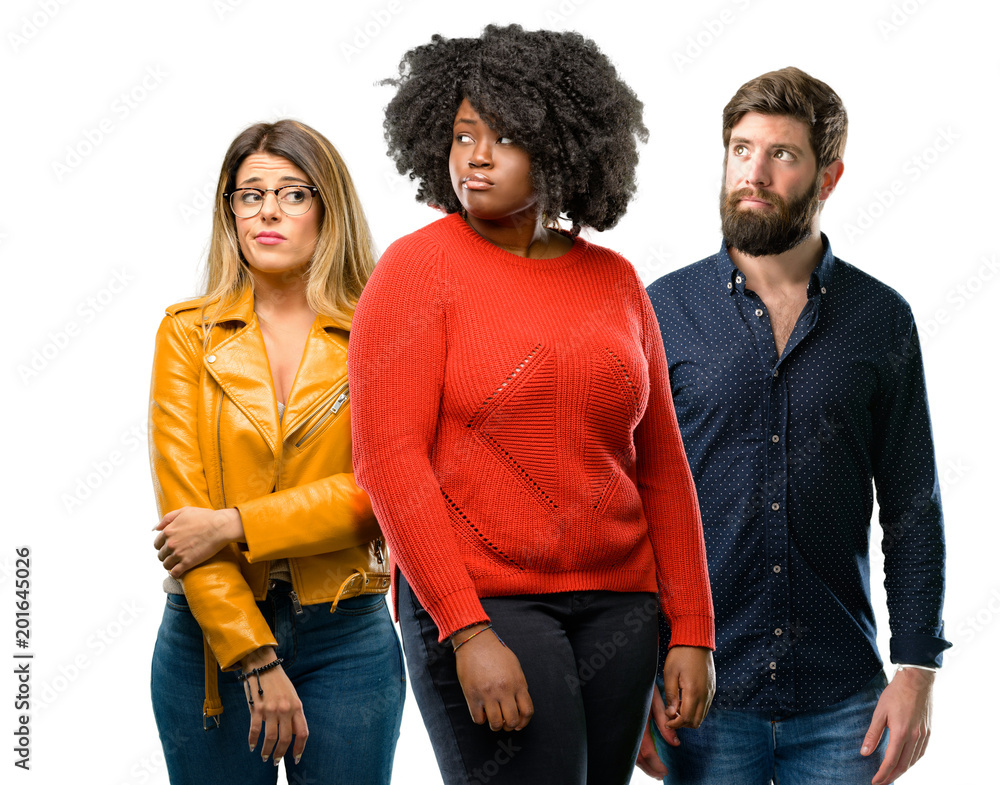 Group of three young men and women doubt expression, confuse and wonder concept, uncertain future Group of three young men and women doubt expression, confuse and wonder concept, uncertain future