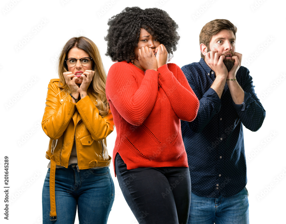 Group of three young men and women terrified and nervous expressing anxiety and panic gesture, overwhelmed Group of three young men and women terrified and nervous expressing anxiety and panic gesture, overwhelmed